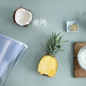 Ingredients for a Coconut and Pineapple smoothie made with Magnesium Mineralized Water for summer