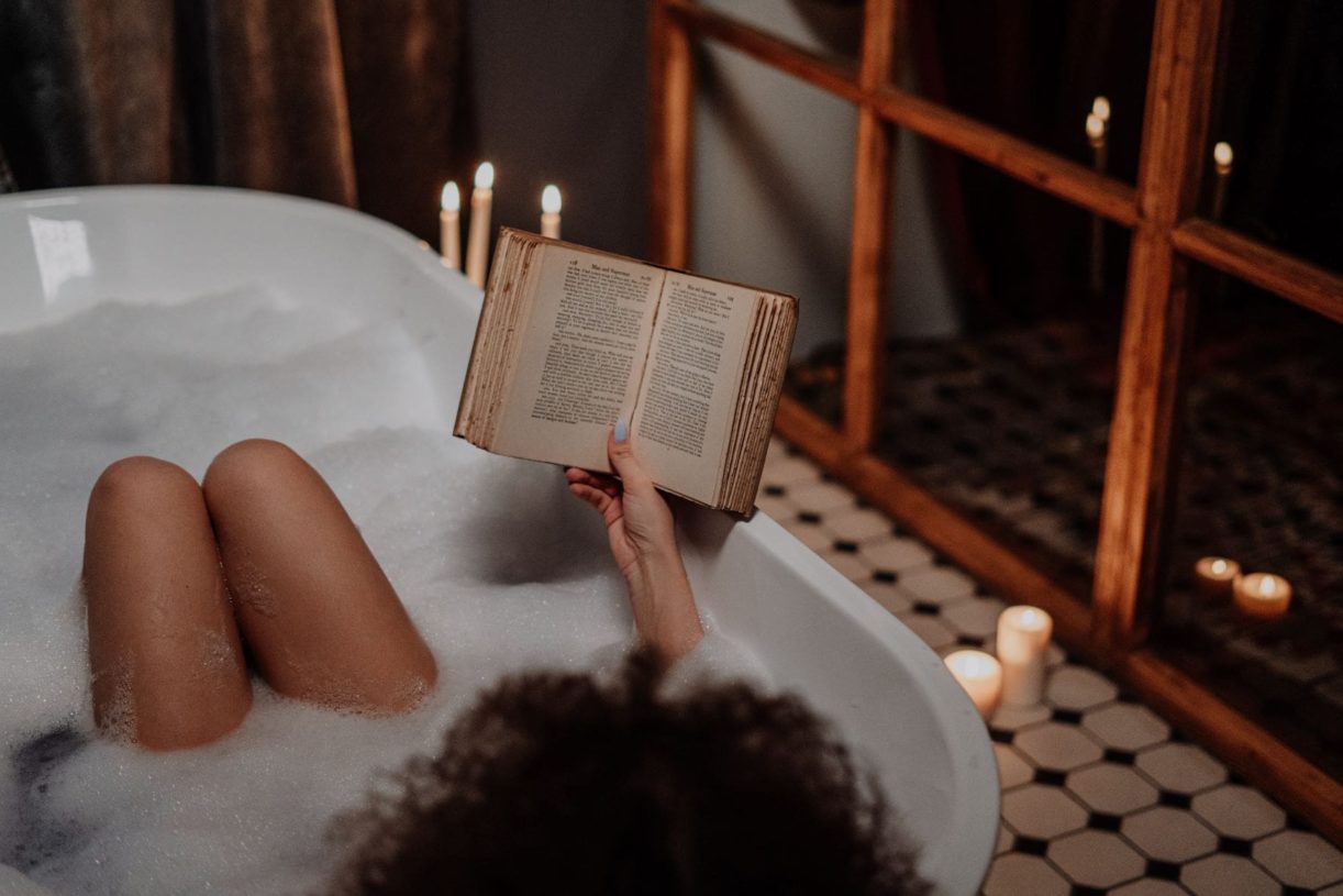 women reading book in the bath