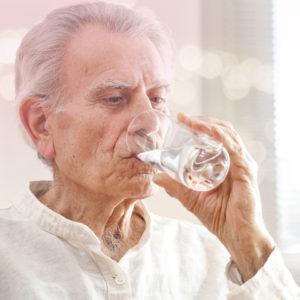 old man drinking water